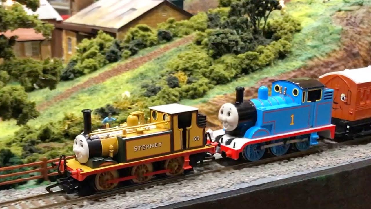 Model trains on a detailed layout with lush scenery